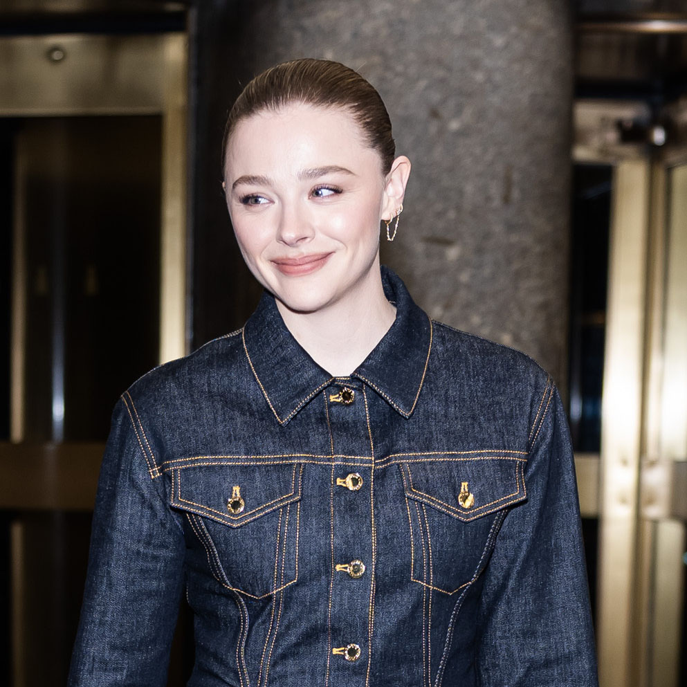 Chloe Grace Moretz wearing dark denim and Louis Vuitton express bag