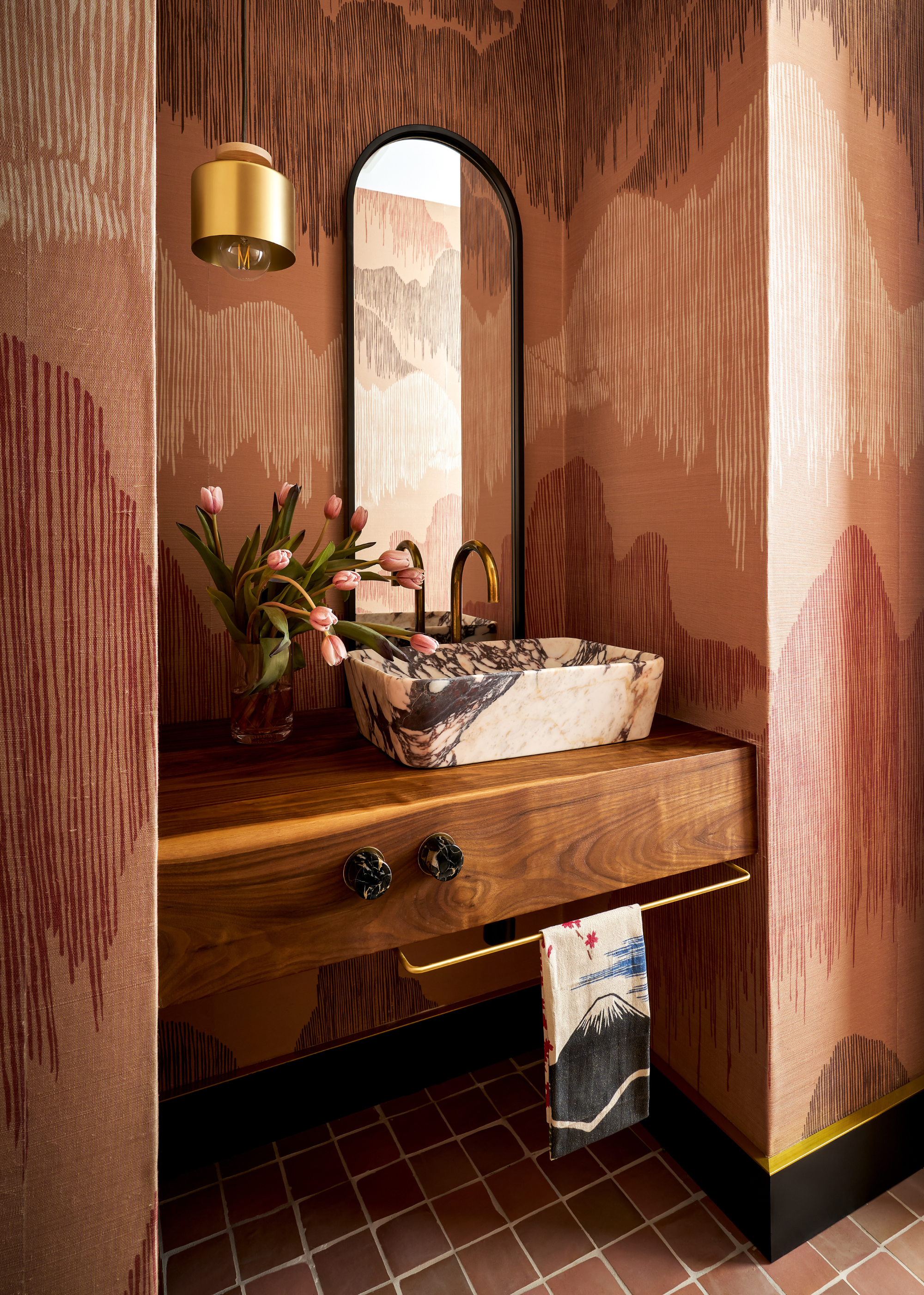A marble basin sat on a floating wooden countertop