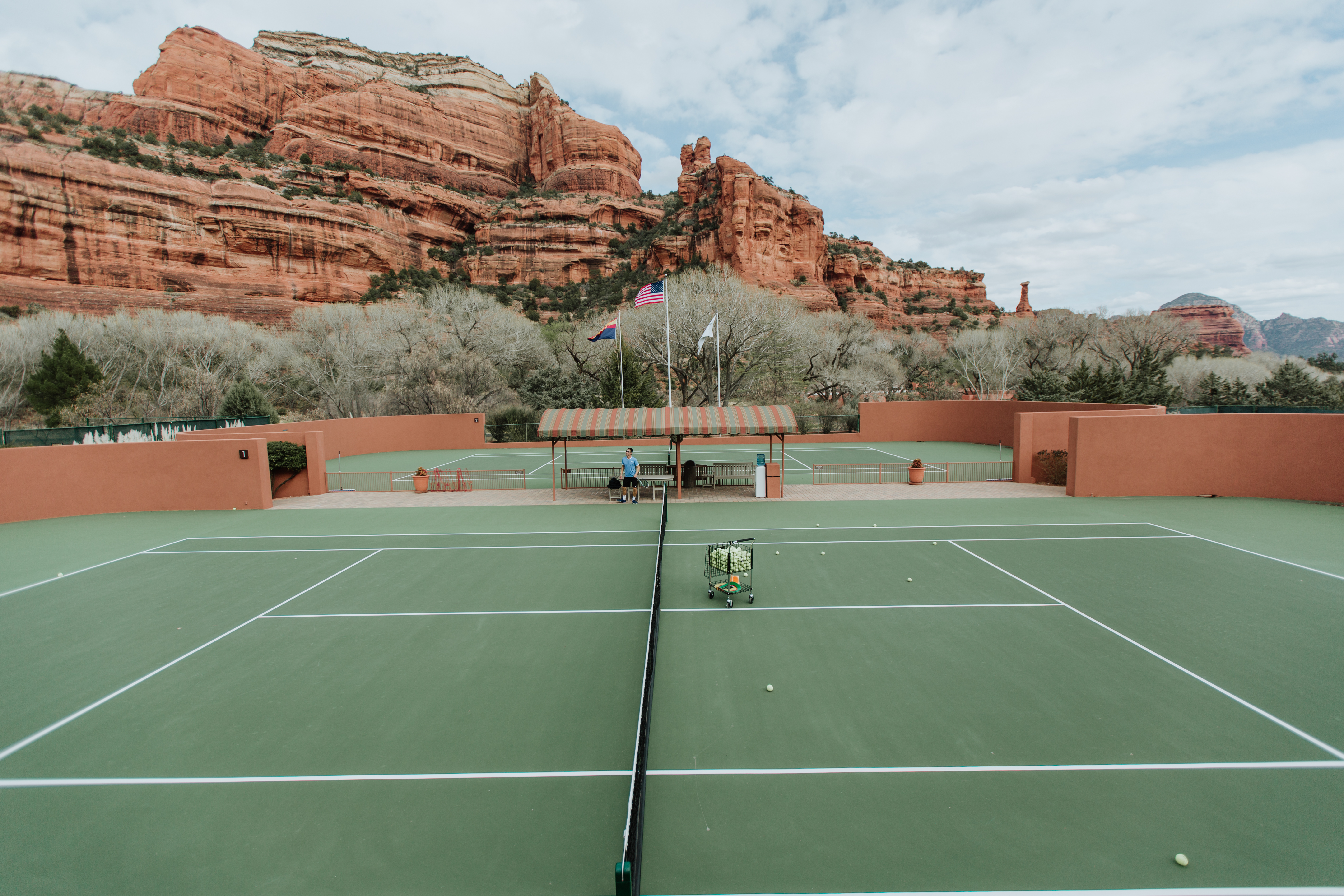 Red rocks make a dramatic backdrop for the tennis and pickleball courts at Enchantment Resort