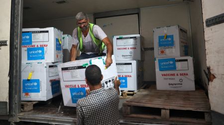 Aid workers unload polio vaccine for Gaza