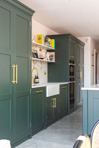 green shaker style kitchen with gold handles