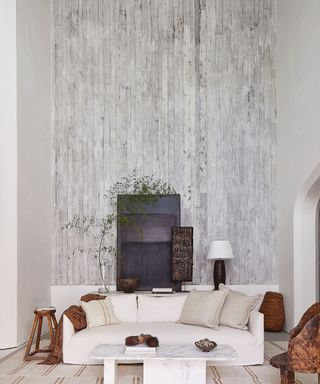 Living room with white textured walls and white sofa