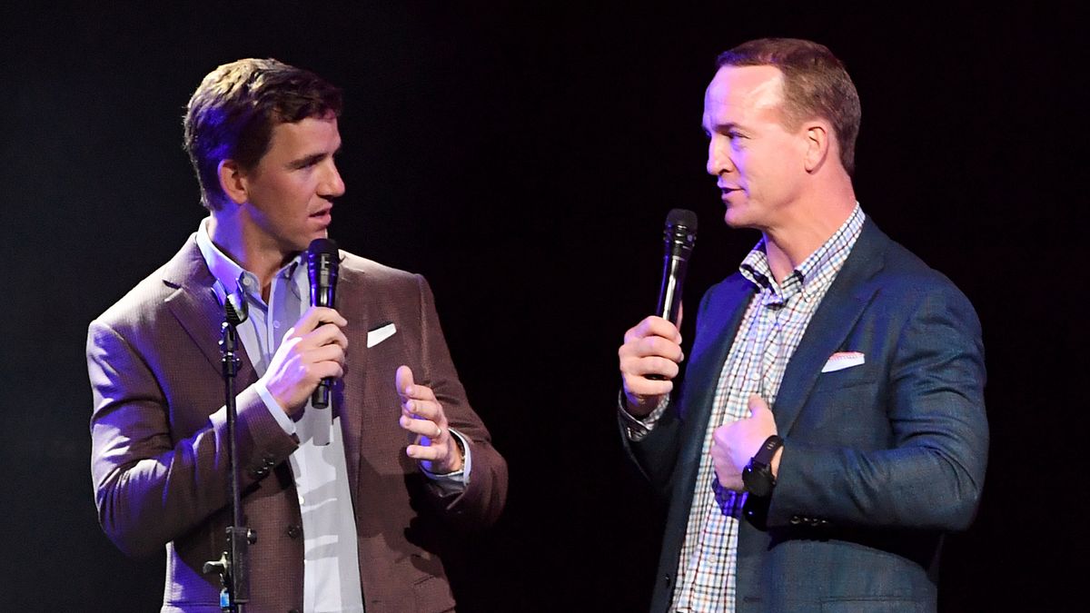 Eli Manning (L) and Peyton Manning speak onstage during the EA Sports Bowl at Bud Light Super Bowl Music Fest on Jan. 30, 2020 in Miami, Florida.