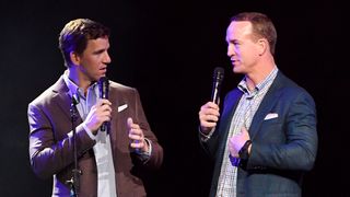 Eli Manning (L) and Peyton Manning speak onstage during the EA Sports Bowl at Bud Light Super Bowl Music Fest on Jan. 30, 2020 in Miami, Florida.