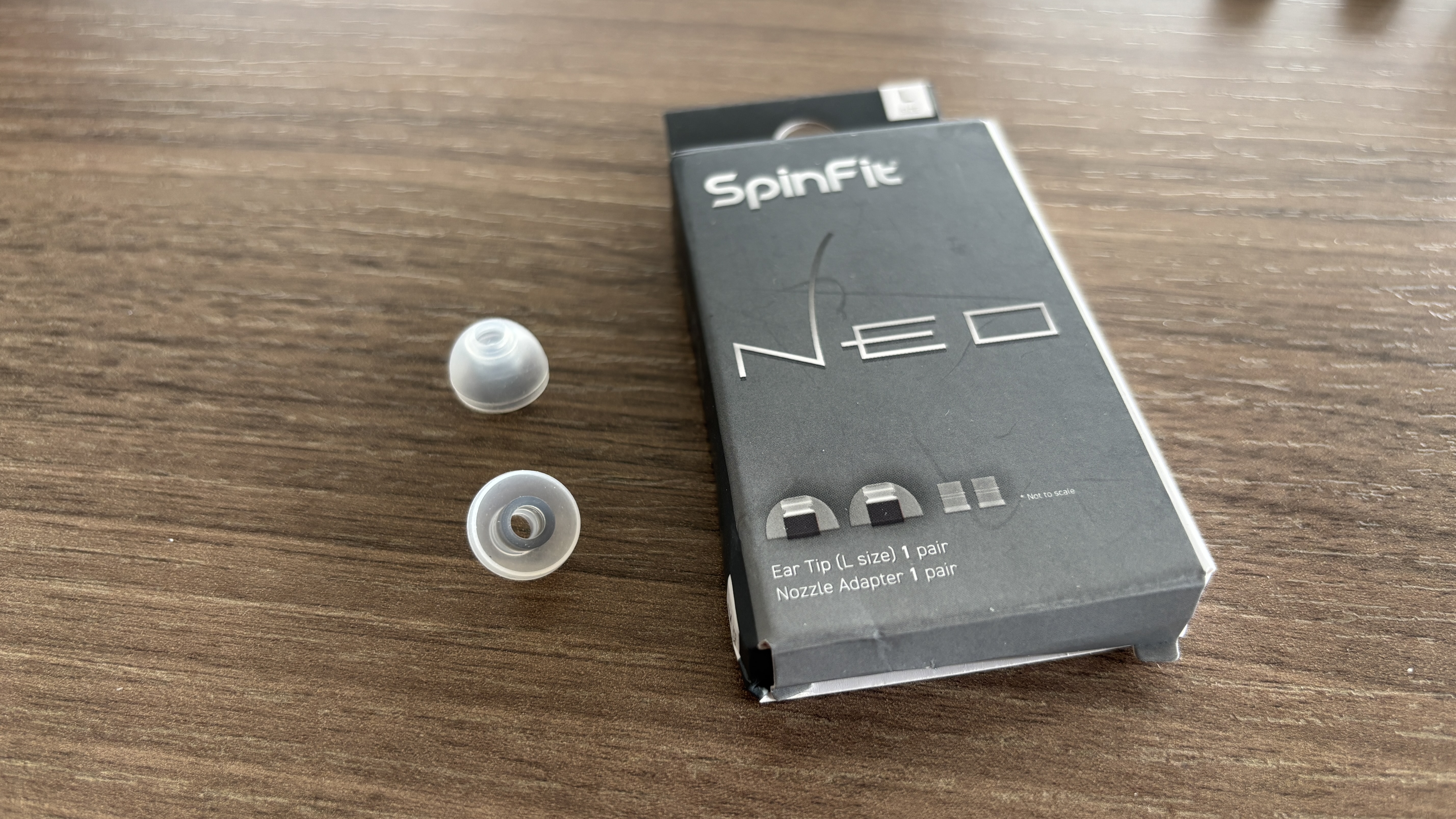 SpinFit Neo eartips on a table next to their packaging