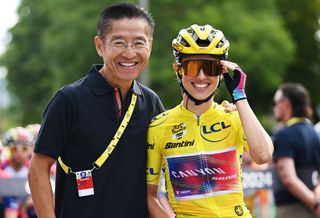 Zwift's CEO Eric Min poses for a photo with race winner Kasia Niewiadoma.