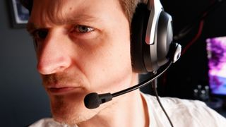 A person wearing the AceZone A-Spire gaming headset with mic extended.