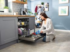 lady packing Beko AutoDose dishwasher