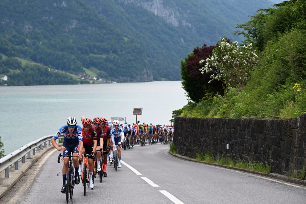 REGENSDORF SWITZERLAND JUNE 10 A general view of Ayco Bastiaens of Belgium and Team Soudal QuickStep Frank van den Broek of The Netherlands and Team dsmfirmenich PostNL lead the peloton climbing to the Kerenzerberg 727m passing through Walensee lake during the 87th Tour de Suisse 2024 Stage 2 a 1773km stage from Vaduz to Regensdorf UCIWT on June 10 2024 in Regensdorf Switzerland Photo by Tim de WaeleGetty Images
