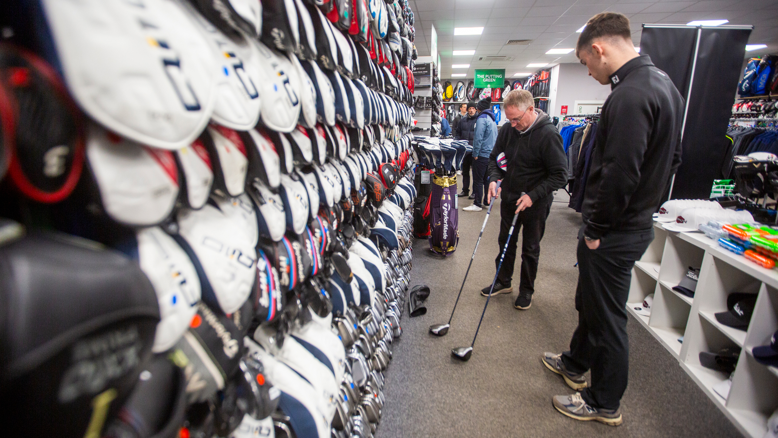 Man looking at clubs at golfclubs4cash