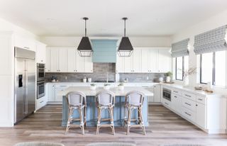 white kitchen with black pendant lighting by Living with Lolo