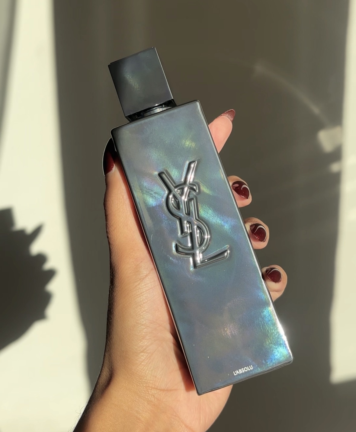 bottle of yves saint laurent fragrance, held by the author