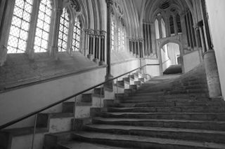 Stone steps in an old building in black and white