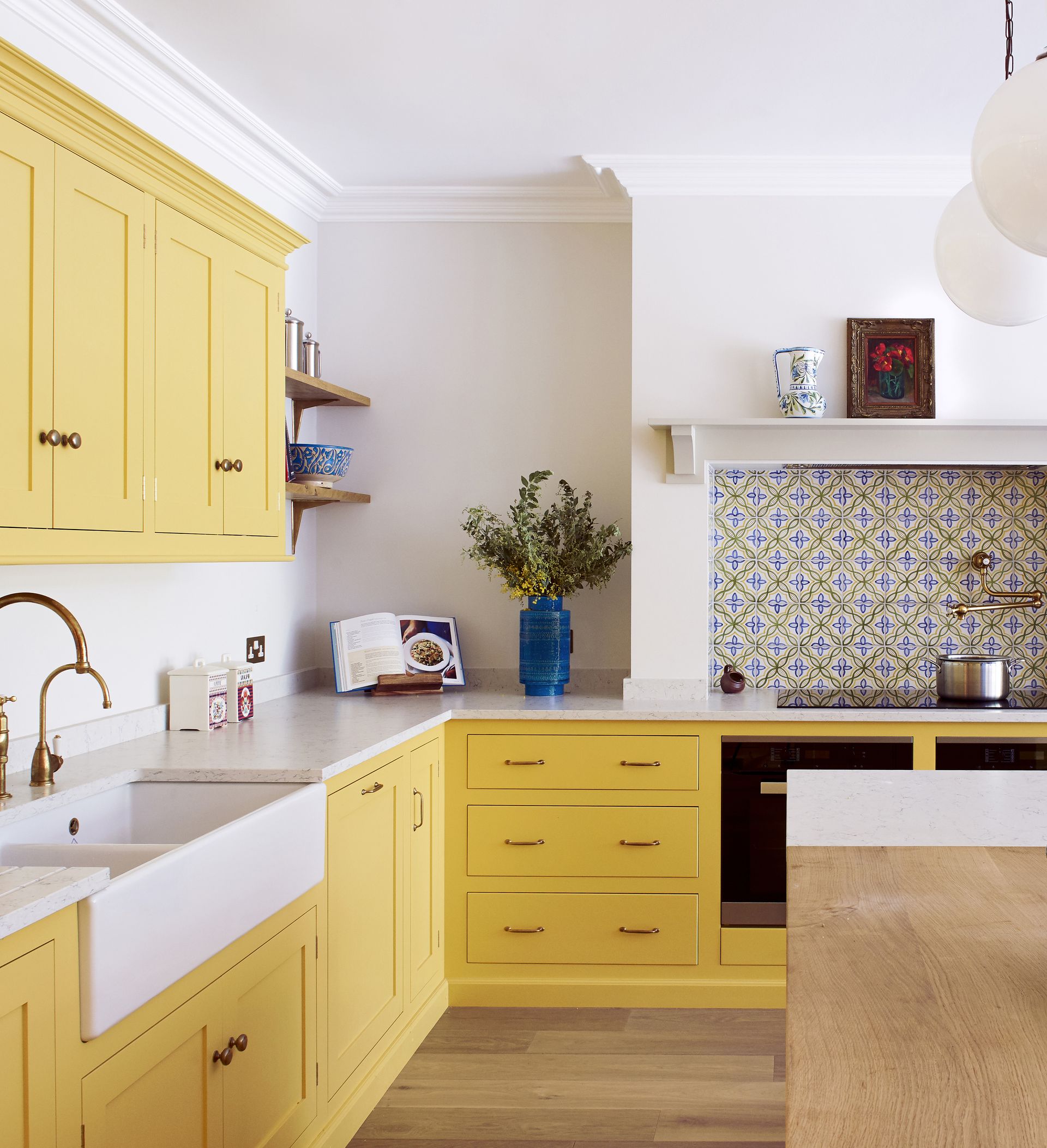A kitchen with bright yellow cabinets