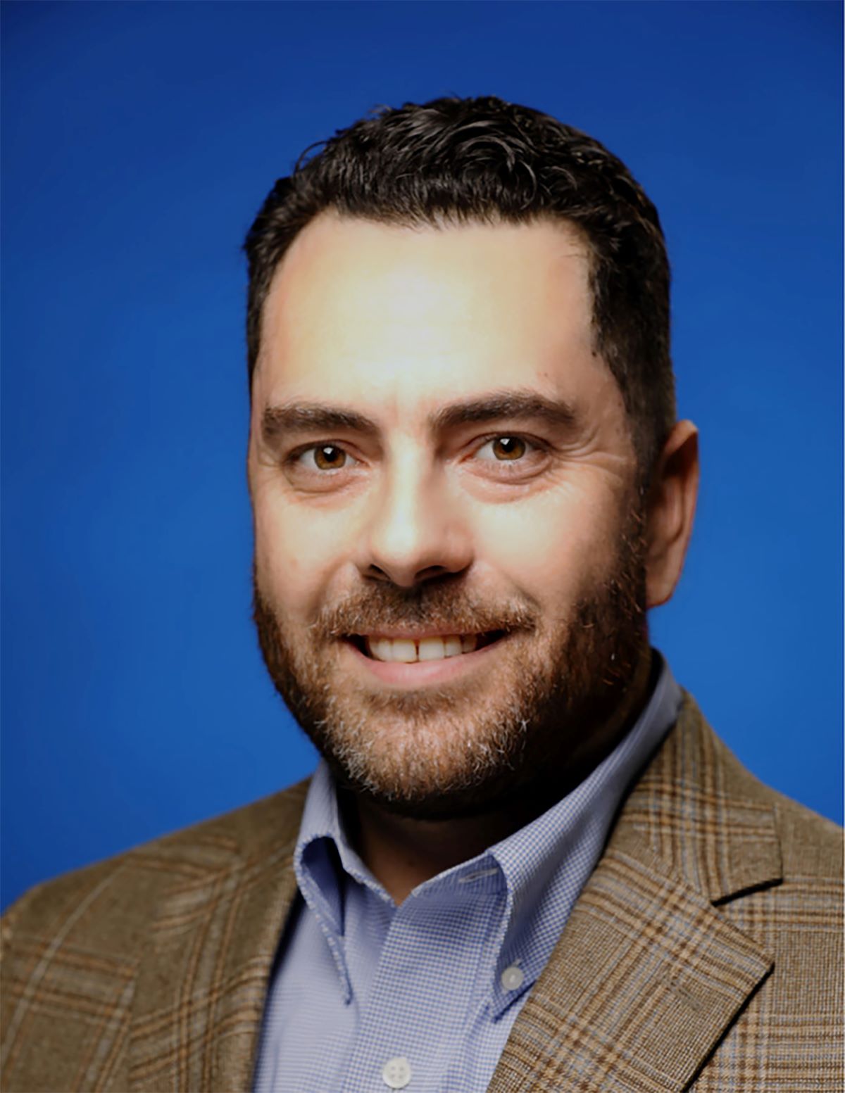 Smiling headshot of Tom Keefe.