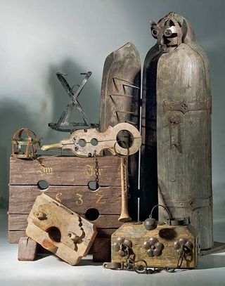 Several torture devices, including an iron maiden, the human-sized box on the right.