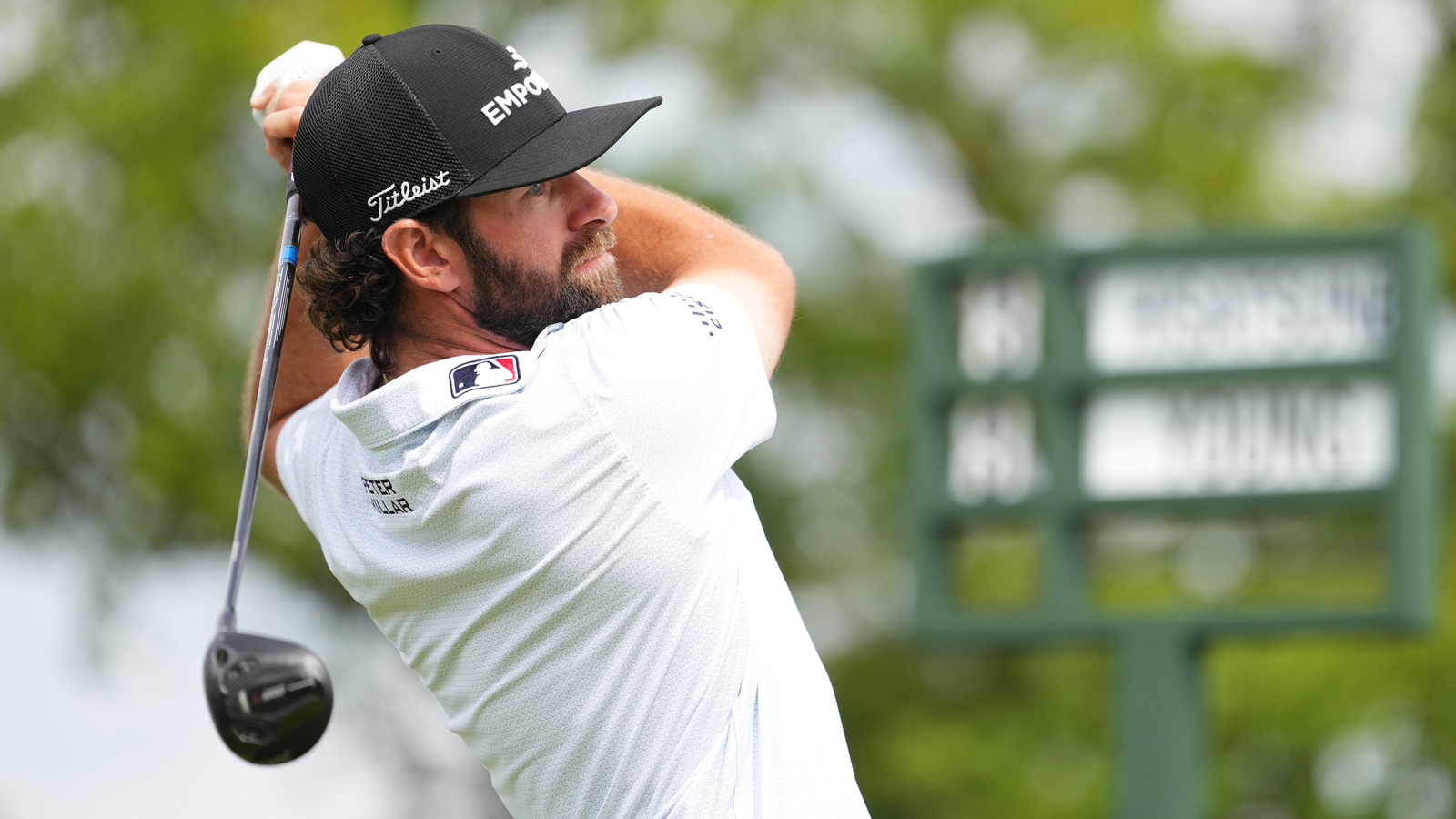 Cameron Young hits a fairway wood