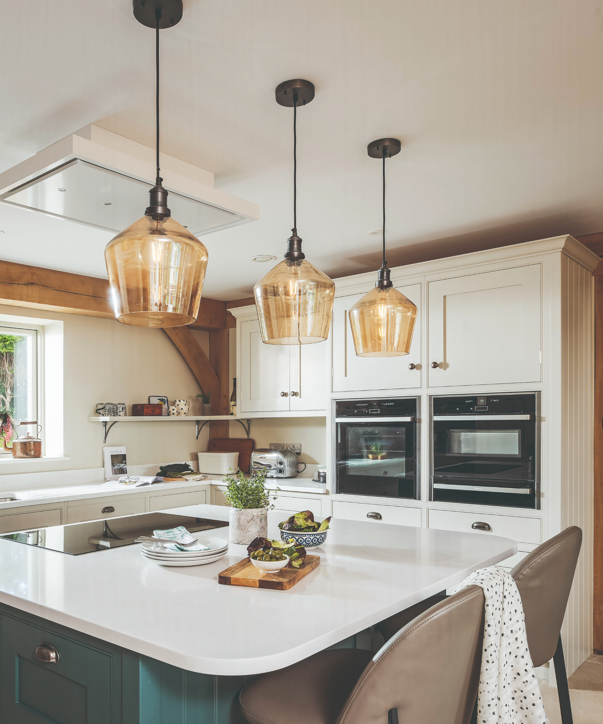 Kitchen island with glass-style shaped hanging lighting