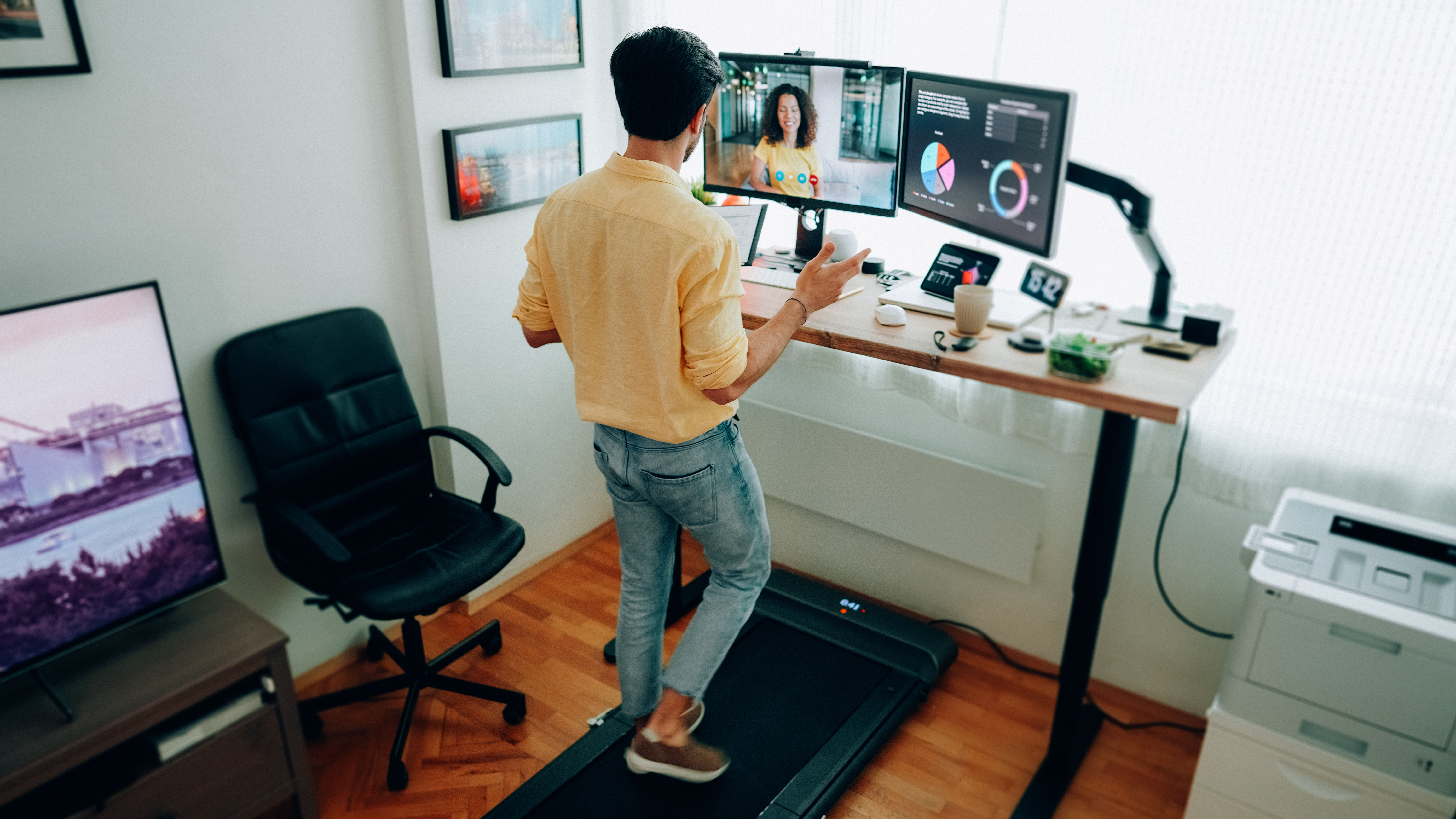 man using under desk treadmill at home