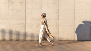 Woman walking along street