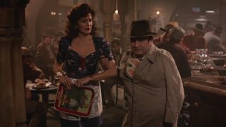 Joanna Cassidy slyly looks over at an annoyed Bob Hoskins with Roger Rabbit stuffed in his coat in Who Framed Roger Rabbit.