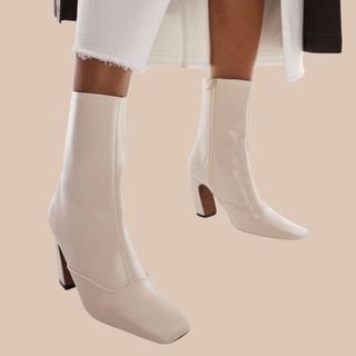 flat lay image of white ankle boots