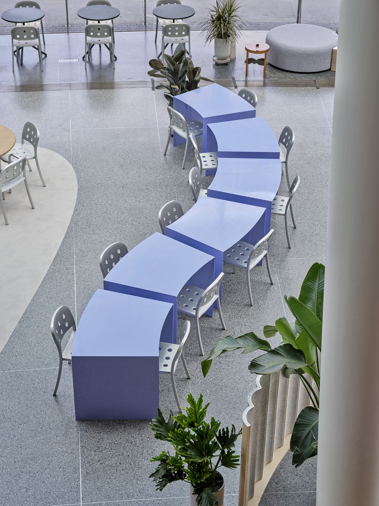 The interiors of the Brooklyn Museum's new cafe feature whimsically shaped and arranged furniture in pastel and metal tones.