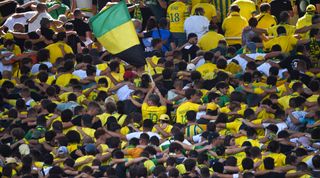 Nantes supporters cheer their team during the French L1 football match between FC Nantes and Toulouse FC at the Stade de la BeaujoireLouis Fonteneau in Nantes, western France on August 28, 2022.