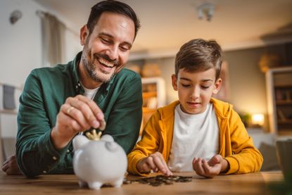 dad and son with piggy bank