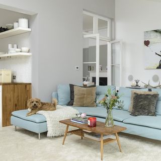 living room with white walls and sofa set with cushion