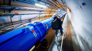A man rides his bike along the particle accelerator at CERN
