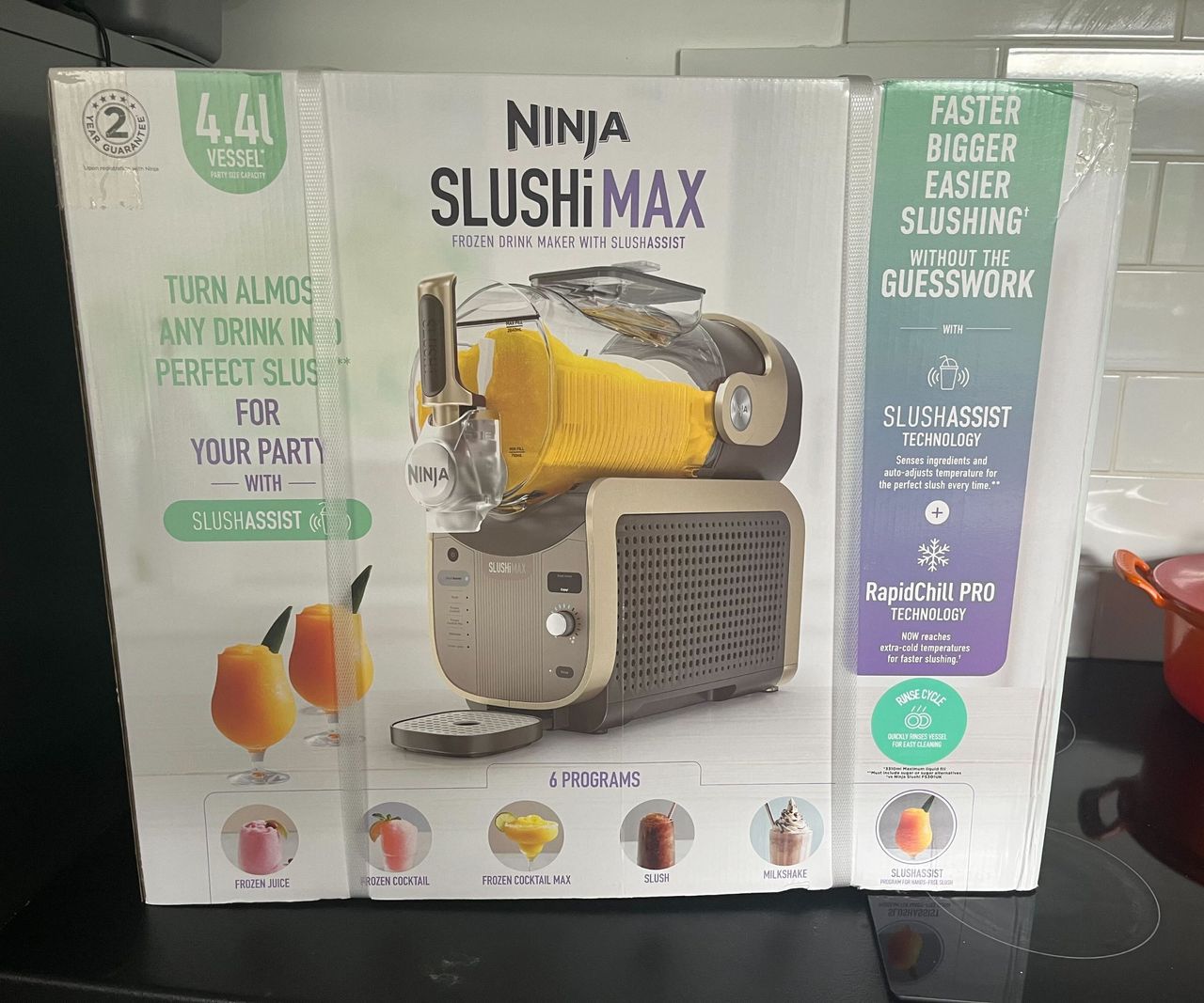 The box for the Ninja Slushi Max on a black kitchen counter.