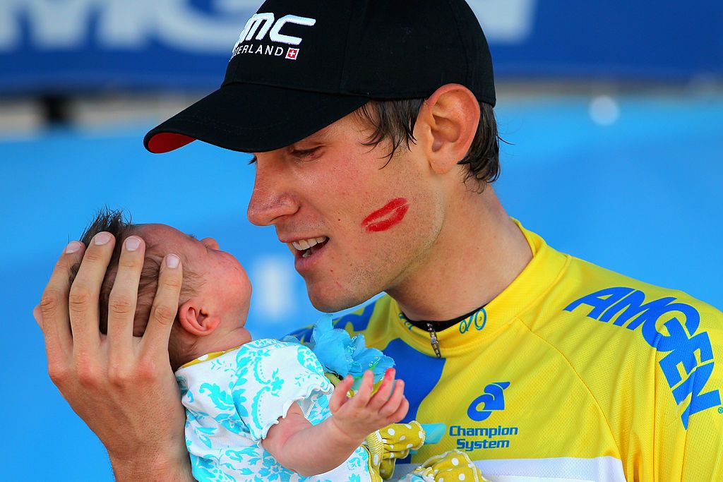 Tejay van Garderen and his newborn child on the podium