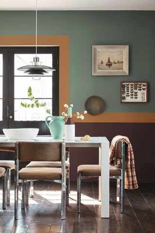 dining table with three different coloured painted on wall, autumnal scheme