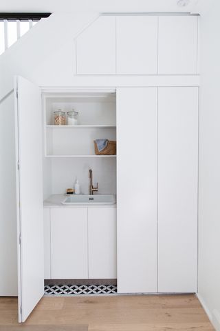 narrow utility room ideas hidden in cupboard under stairs