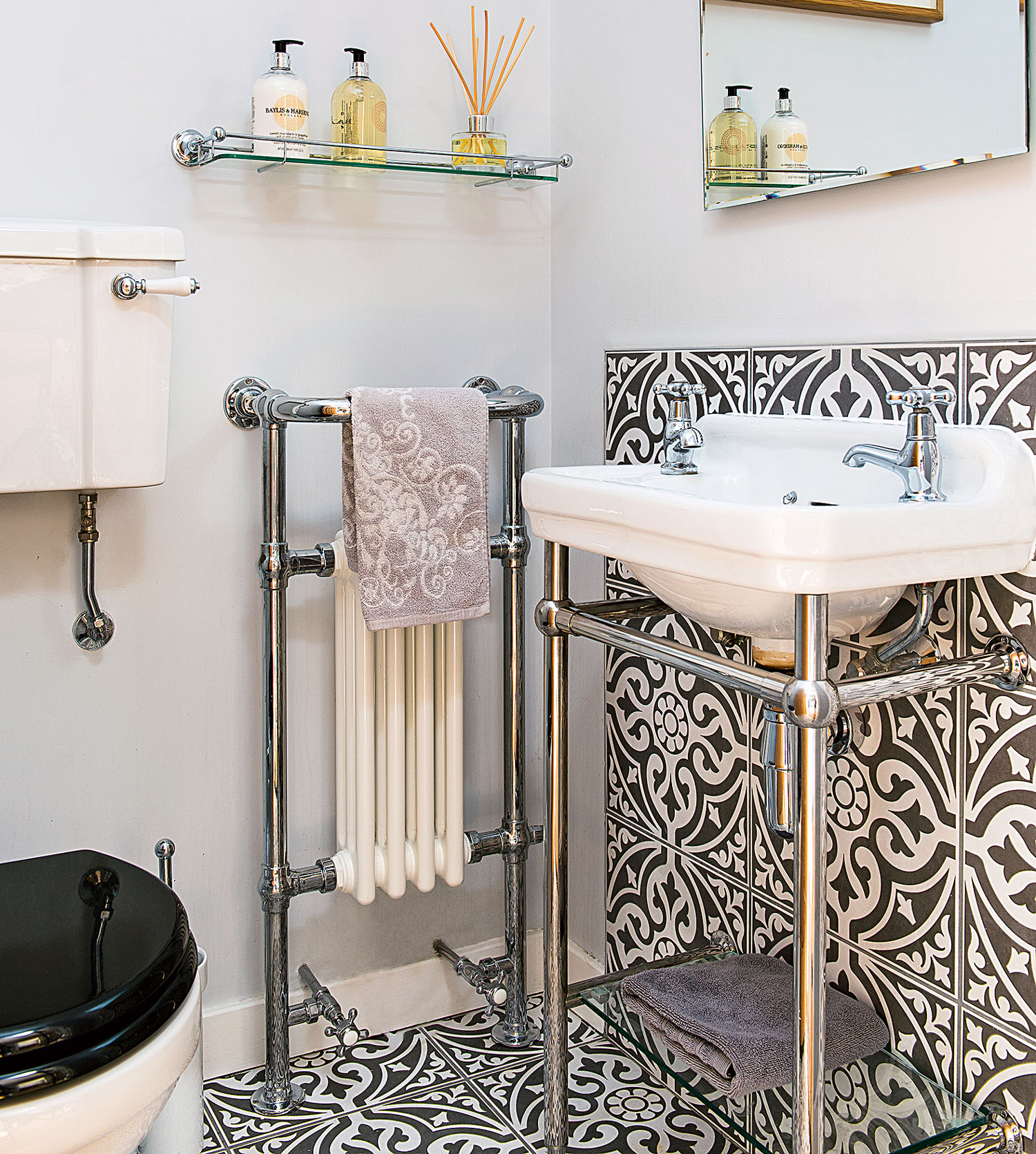 bathroom with white coloured and radiator and basin