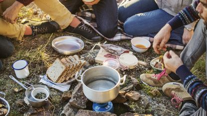 Friends preparing breakfast at campsite