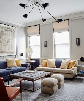 Small living room ideas for apartments featuring gold and blue sofas and cushions in a traditional, neutral scheme.