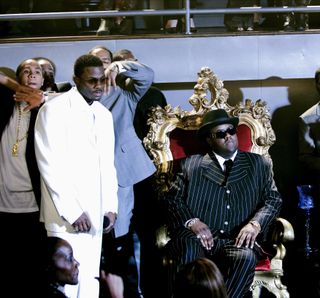 a man in a white suit and a man wearing a suit on a throne in the movie notorious