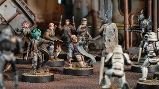 Fully-painted models of Rebel soldiers face off against Stormtroopers on a sci-fi battlefield in a game of Star Wars: Legion