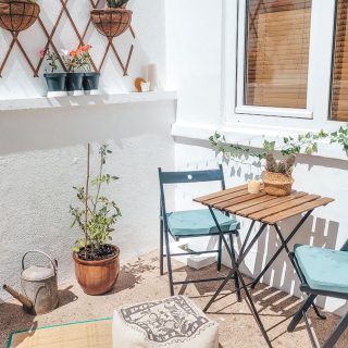 wooden table with chairs and plants