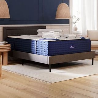 A DreamCloud Luxury Hybrid Mattress on a grey bed in a bedroom