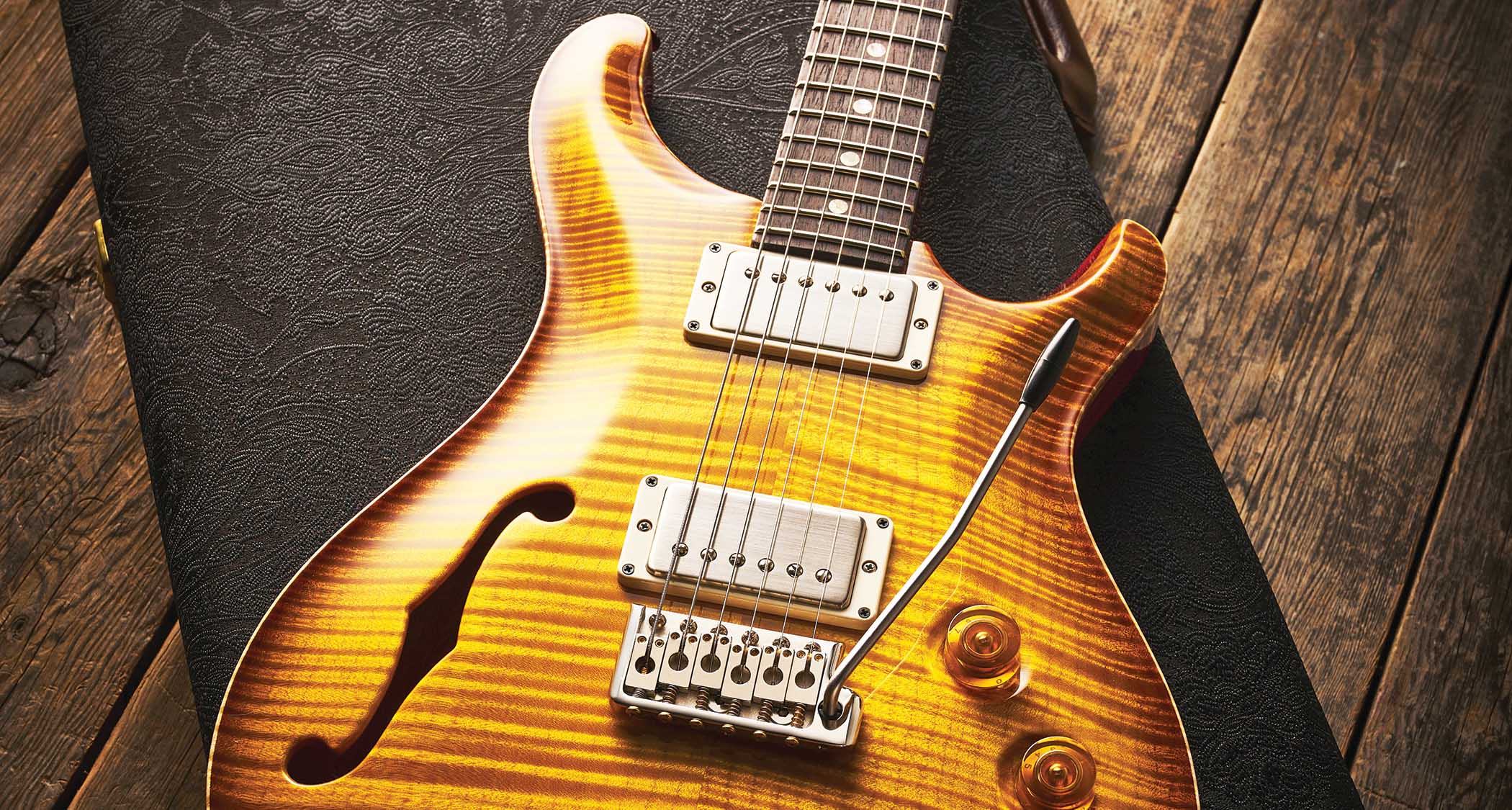 A PRS Hollowbody photographed on top of its case