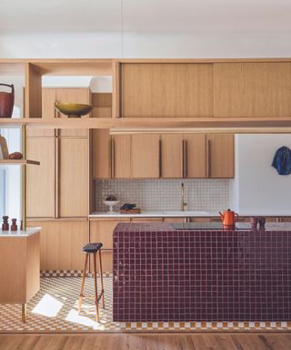 Wooden kitchen with red tiled island