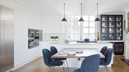 white and blue kitchen dining area with island