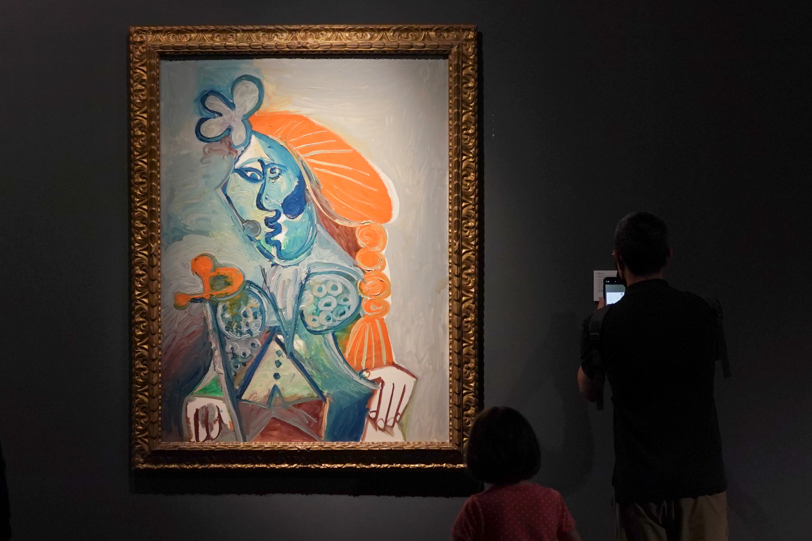 A Picasso painting in a frame on a wall