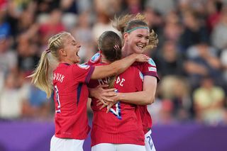 Signe Gaupset of Norway celebrates with teammates Emilie Woldvik and Maren Mjelde after scoring her team's first goal during the UEFA Women's EURO 2025 Group A match between Norway and Iceland at Arena Thun on July 10, 2025 in Thun, Switzerland.