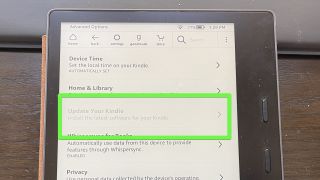 A Kindle Oasis with "Update Your Kindle" highlighted and grayed out.