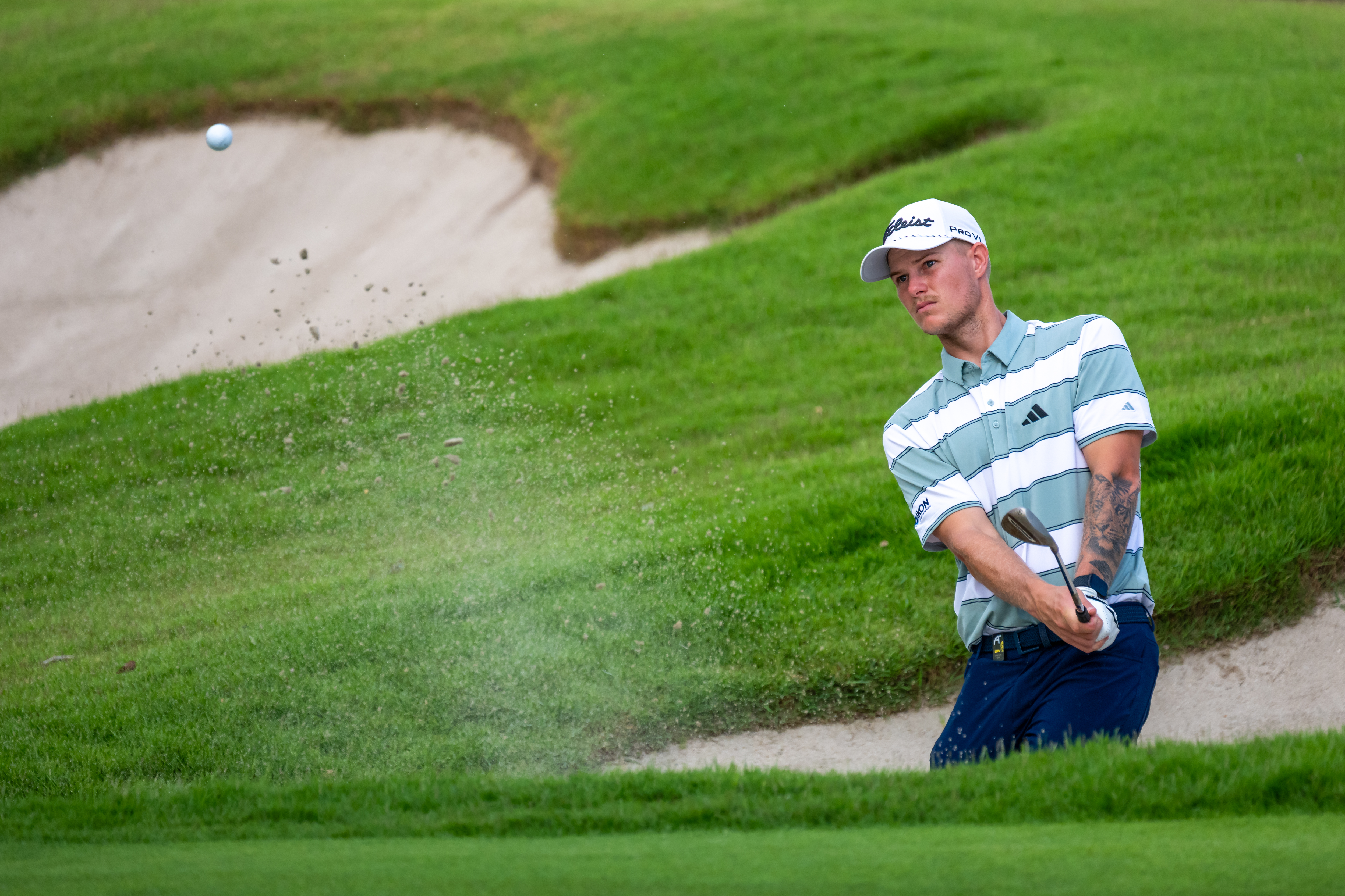Cameron John plays a bunker shot during the final round of the 2026 Singapore Open