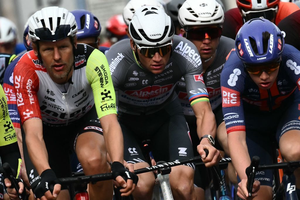 Dutch Mathieu Van Der Poel of team Alpecin-Deceuninck (C) and Dutch Taco Van Deer Hoorn (L) of team Intermarche ride in the pack during the Milan - Sanremo one-day classic cycling race, on March 22, 2025. (Photo by Marco BERTORELLO / AFP)